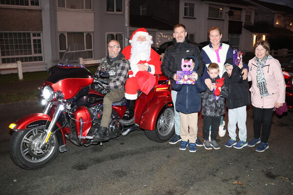  The Power family with Santa, who enlisted the help of Celtic Thunder Chapter Ireland to help deliver pre-Christmas presents to the children at Hillview estate.