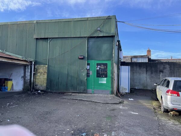 The open shed is to the left of the store entrance, as pictured. 