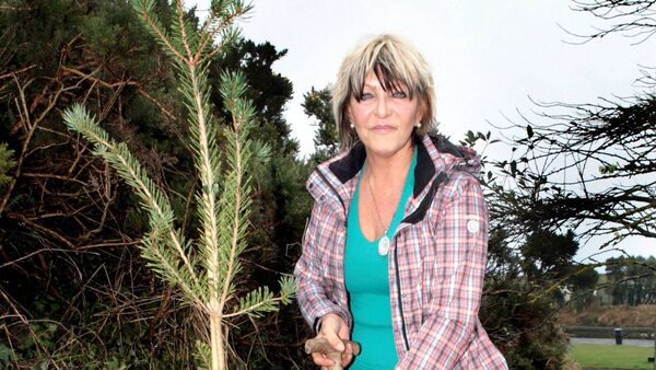 Christina Donnolly, planting a tree at Bonmahon in memory of her son Brendan. Photo: Joe Evans