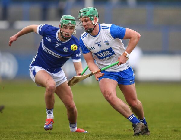 Waterford’s Jack Prendergast in control ahead of Laois’ Jordan Walshe. 