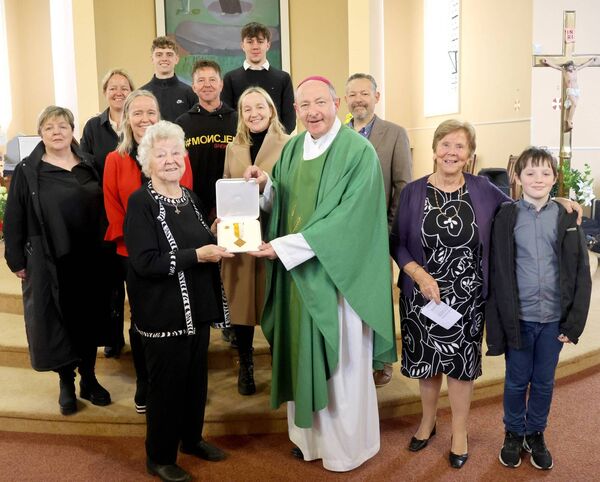 Bishop Alphonsus Cullinan presented The Benemerenti Meadal to Mae Mc Grath for her services to the choir at Ballybricken Church. Photo: Joe Evans