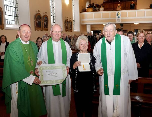 The Benemerenti Meadal was presented to Mae Mc Grath for her services to the choir at Ballybricken Church, from left are, Bishop Alphonsus Cullinan, Fr. Tom Rogers, Mae McGrath and Fr. Michael Mullins. Photo: Joe Evans