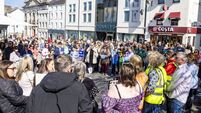 'Let them in!'- Scores gather in city for protest