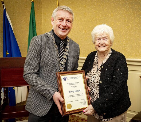 Mayor of Waterford City &amp; County Council Cllr Jason Murphy pictured presenting a scroll to Betty Gough, in recognition of her unwavering dedication and invaluable contributions to her local community. Photo: Joe Evans