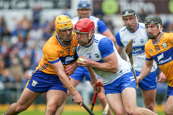 Waterford's Tadhg De Burca is tackled by Clare's Mark Rodgers.
