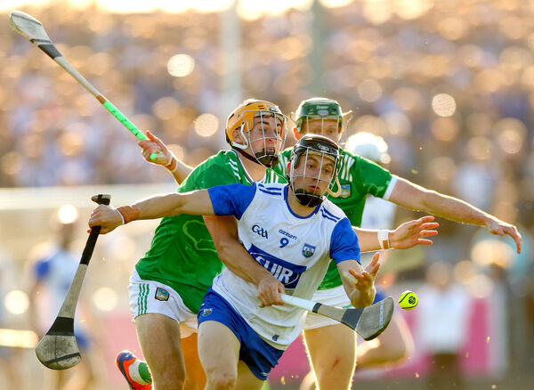 Waterford's Jamie Barron tries to get away from Limerick's Adam English and Will O'Donoghue 