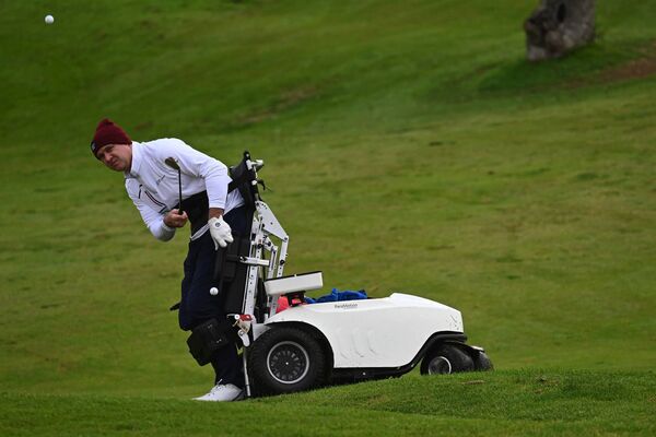 Ian St. John takes a shot on the golf course. Ian St. John takes a shot on the golf course.