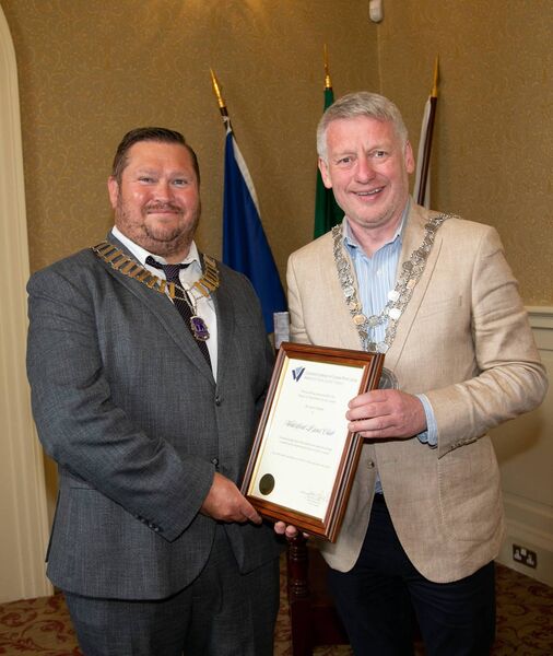 Mayor of Waterford City and County Cllr. Jason Murphy making a presentation to Lions Club President William Cuddihy. Photo: John Power