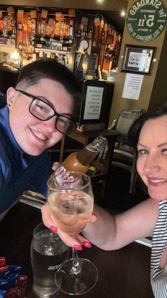 Kim Bergin raising a glass at her 21st birthday with proprietor of The Sweep Michelle Dunphy.