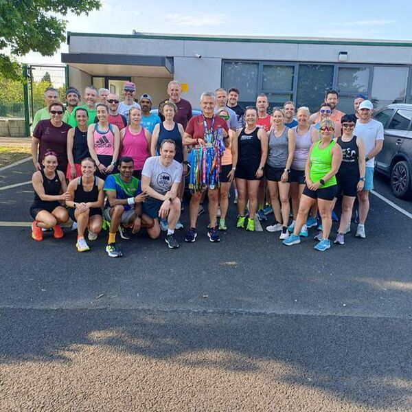 Shane McDonnell displaying his 50 marathon medals with his fellow running buddies.