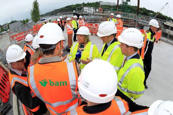 Ministers Mary Butler, James Browne and John Cummins speaking to local media during the bridge installation last week
