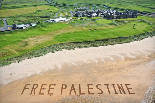 The Art Hand created the 'Free Palestine' message on the shorefront at one of President Donald Trump's golf resorts, in Ireland. The Art Hand created the 'Free Palestine' message on the shorefront at one of President Donald Trump's golf resorts, in Ireland.