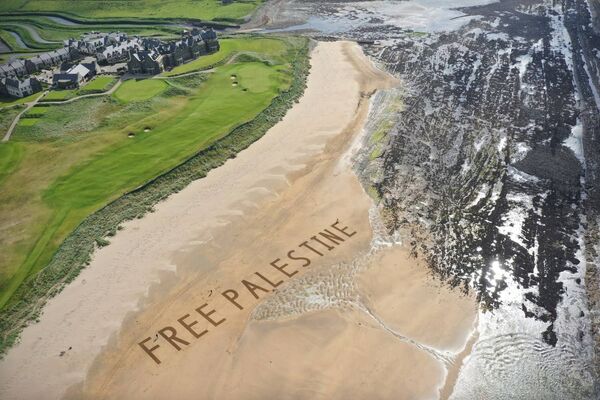 The Art Hand created the 'Free Palestine' message on the shorefront at one of President Donald Trump's golf resorts, in Ireland. The Art Hand created the 'Free Palestine' message on the shorefront at one of President Donald Trump's golf resorts, in Ireland.