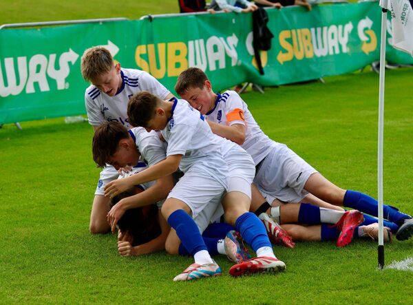 Waterford's Max Chren is mobbed by his teammates after scoring the winning in the Plate final against Limerick District.