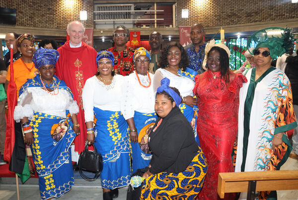  Fr. Liam Power with members of the African community at the Pentecost Sunday Celebration at St. Joseph and St Benildus Church.