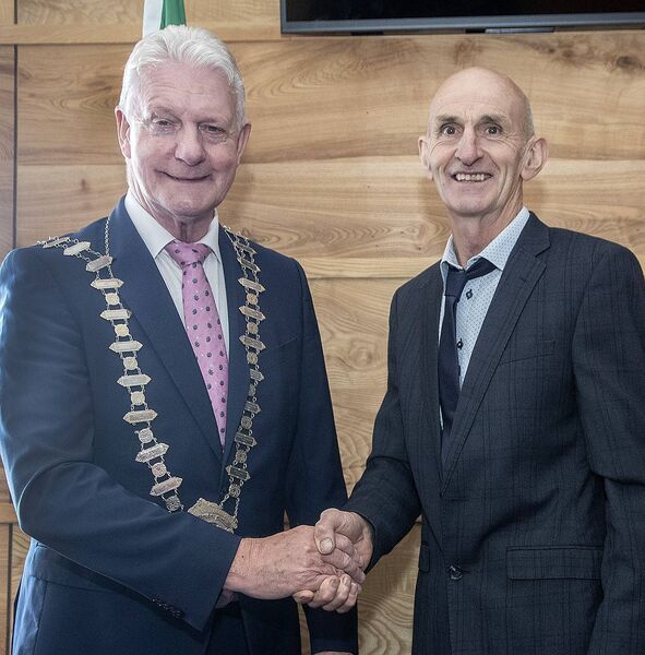 Cllr. Seanie Power, outgoing Chairperson, congratulating newly elected Cathaoirleach Cllr John O'Leary. Photo: Sean Byrne