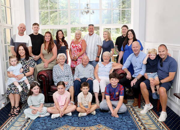  Tom and Evelyn Collins surrounded by their family.