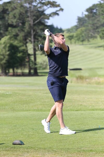 Tommy Waring tees off. 