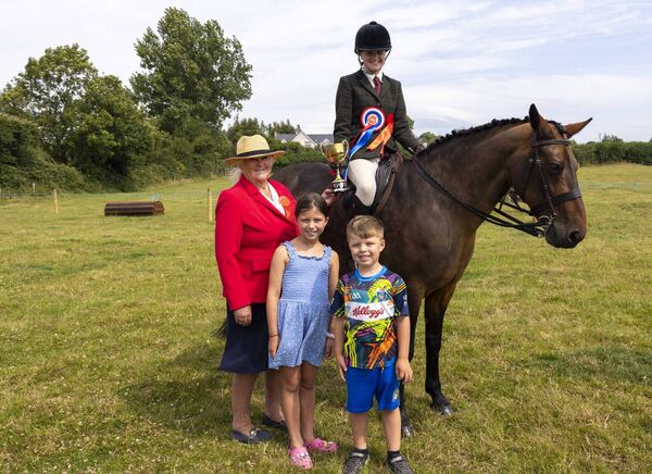 Isabel O’Donnell, Champion Show Hunter receiving Ita Carroll Cup from Carol Adams (Judge) Jenny Fitzgerald and Billy Fitzgerald.