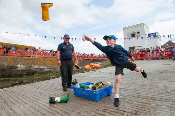 Thomas Ó Droma participating in the Welly Throwing Contest during the Helvick Swim event in 2024. Pic: Andrew Miller. Thomas Ó Droma participating in the Welly Throwing Contest during the Helvick Swim event in 2024. Pic: Andrew Miller.