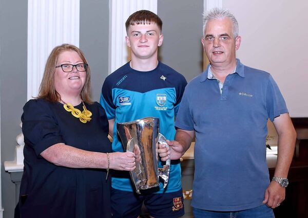 Waterford minor hurling team member Darragh Keane pictured with the Irish Press cup and parents Linda and Joe Keane.
