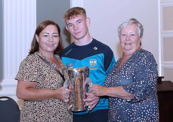 Waterford minor hurling team member Eoin Burke pictured with the Irish Press cup and his mother Mary Burke and grandmother Marian Murphy.