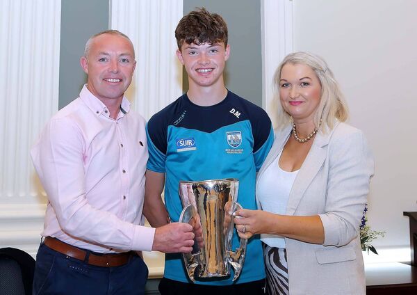 Waterford minor hurling team member Dylan Murphy pictured with the Irish Press cup and parents, Daniel and Olivia Murphy.