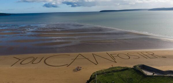 Tusla foster families from Waterford and Wexford came together to create the world's largest ever sand message, 'You CAN foster' Photo: Nichola Browne-Sinnott