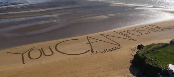 Tusla foster families from Waterford and Wexford came together to create the world's largest ever sand message, 'You CAN foster' Photo: Nichola Browne-Sinnott