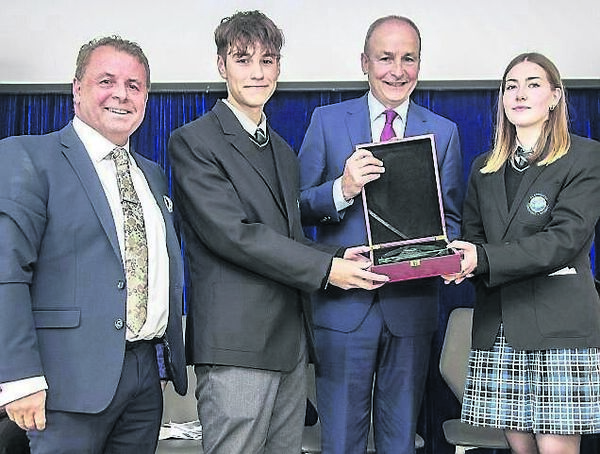 Head Students at Blackwater Community School David Feeney and Ava Landers making a presentation to Taoiseach Micheál Martin, also included is Denis Ring, Principal. Photo: Sean Byrne