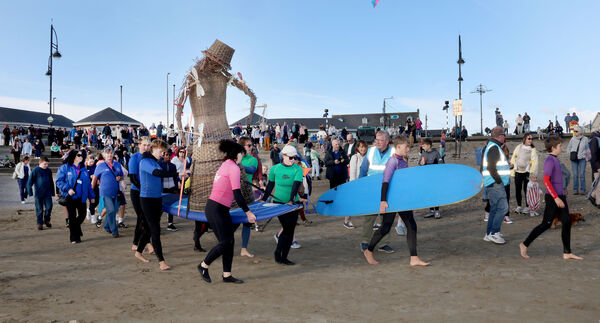  Members of T-Bay Surf Club carry the Molly Doll to the Sea at the Vitamin Sea Festival in Tramore. Photo: Joe Evans