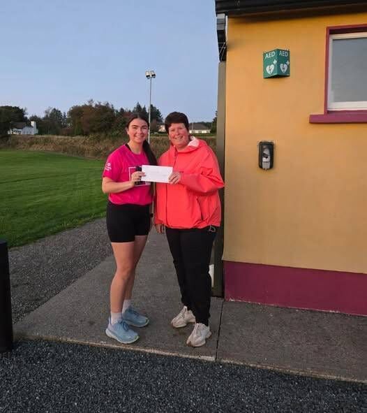Regina Carroll presents Clara Harte with her prize at the Touraneena Runner’s Club ‘Predict Your Time’ league.