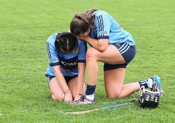 The other side of the coin as Gailltir's Maeve Sheridan is consoled by her teammate and joint captain Clodagh Carroll at the final whistle. The other side of the coin as Gailltir's Maeve Sheridan is consoled by her teammate and joint captain Clodagh Carroll at the final whistle.
