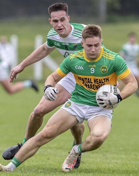 Kilrossanty's Padraig Fitzgerald with the ball ahead of Ballinacourty's Michael Kiely Kilrossanty's Padraig Fitzgerald with the ball ahead of Ballinacourty's Michael Kiely