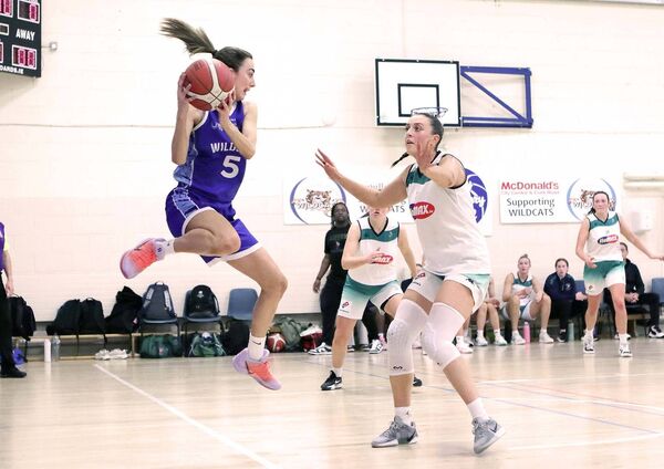 Helena Rohan (Wildcats) just about manages to keep the ball in play with this acrobatic leap. Helena Rohan (Wildcats) just about manages to keep the ball in play with this acrobatic leap.