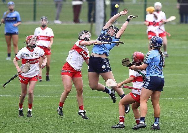 Gailltir's Laoise Forrest shows no fear as she battles for possession, surrounded by De La Salle combatants. Gailltir's Laoise Forrest shows no fear as she battles for possession, surrounded by De La Salle combatants.