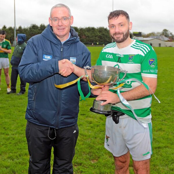 Waterford GAA Chairperson Neil Moore presents Ballinacourty captain Nicky Dee with the J.J. Kavanagh & Sons sponsored Junior B title. Waterford GAA Chairperson Neil Moore presents Ballinacourty captain Nicky Dee with the J.J. Kavanagh & Sons sponsored Junior B title.