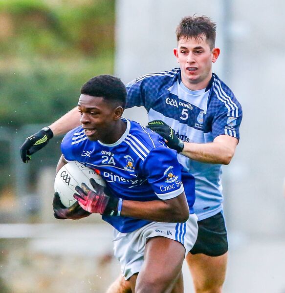 Mount Sion's Emanual Adebayo tries to put Kilmacthomas's Dean Walsh under pressure.