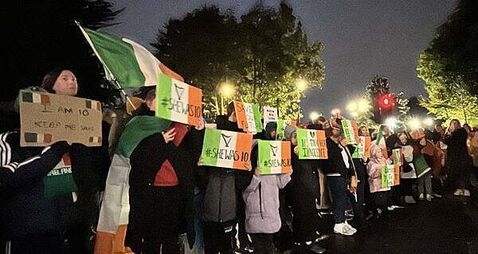 Protesters let off pink smoke during asylum demonstration at Citywest