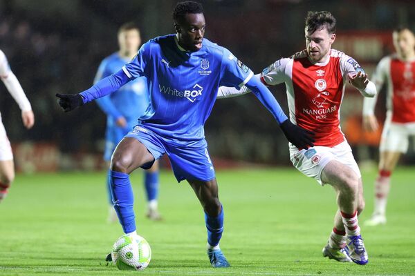 Waterford FC's James Olayinka tries to hold off the intentions of St. Pat's Jason McClelland.  Waterford FC's James Olayinka tries to hold off the intentions of St. Pat's Jason McClelland.