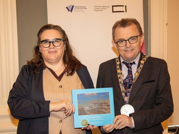 Mayor Seamus Ryan presenting a copy of 'Sea and Stone', to Archivist Joanne Rothwell, speaker at the Waterford-Newfoundland Heritage Connections Seminar in City Hall. Photo: John Power