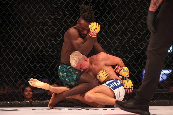 Waterford's Solomon Simon, seen here controlling the fight against Marko Sarasjarvi, is the new featherweight champion of the world. Photo: ©INPHO/Bryan Keane