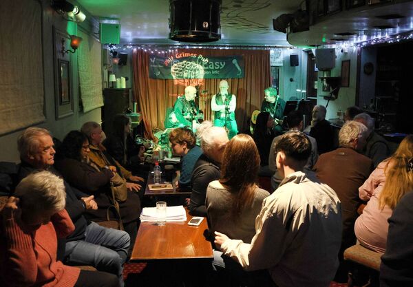 Settling in for an evening of poetry, open mic performance and music at SpeakEasy at Phil Grimes Pub.