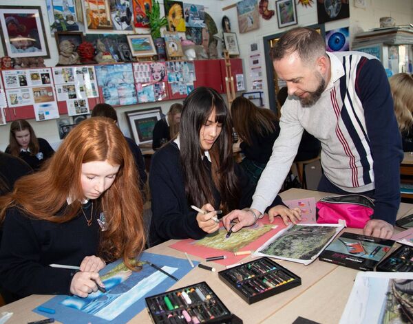 Students Eve Burton and Valerie de los Reyes with Oil Pastel Visual Artist Declan O'Meara. Photo: John Power