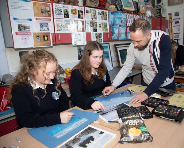 Students Mia McAreavey and Taelyn Rempel with Oil Pastel Visual Artist Declan O'Meara. Photo: John Power