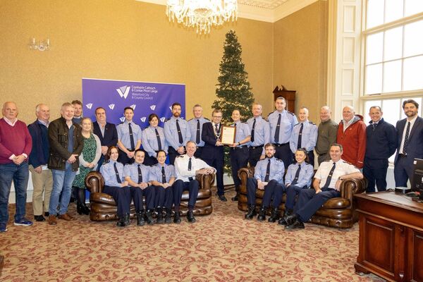 Garda David  and Garda Ciara Heffernan accepted the scroll on behalf of the community Garda from Mayor Ryan . Photo: Joe Evans