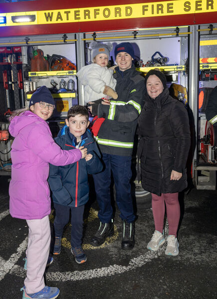  Éanna, Caoimhín, Ríadh and Ciara with Fireman Sean, at the Winterval Blue Light Parade.