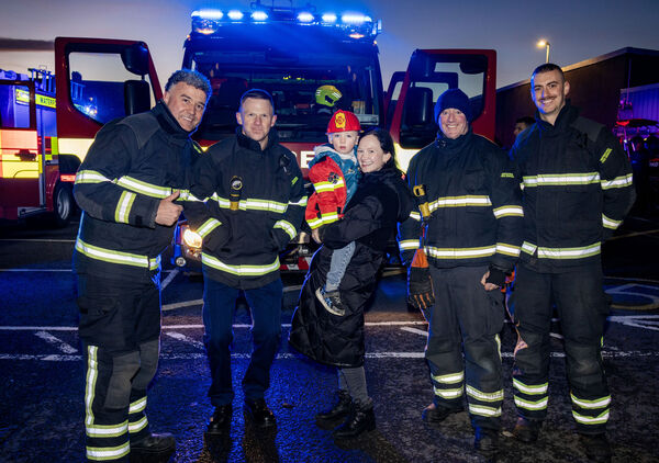  Caelan and Noreen, with members of Waterford City Fire Service, at the Winterval Blue Light Parade.