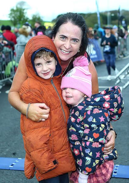 Carol Murphy with her children Oran and Keva as she crossed the finish line.