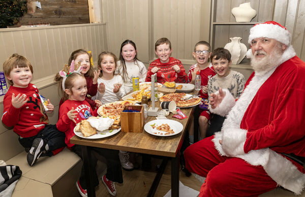  Santa paid a surprise visit to Moes Tramore and is pictured here with members of the Walsh, Kearns and McGivern family's. Photo: Joe Evans